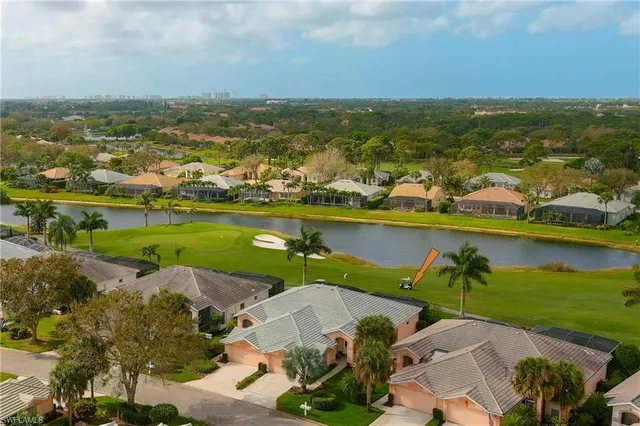 an aerial view of a houses with a lake view
