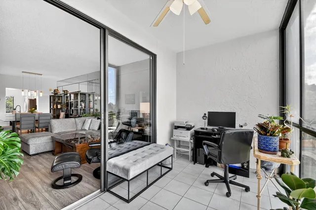 a front view of a residential apartment building with a yard and plants