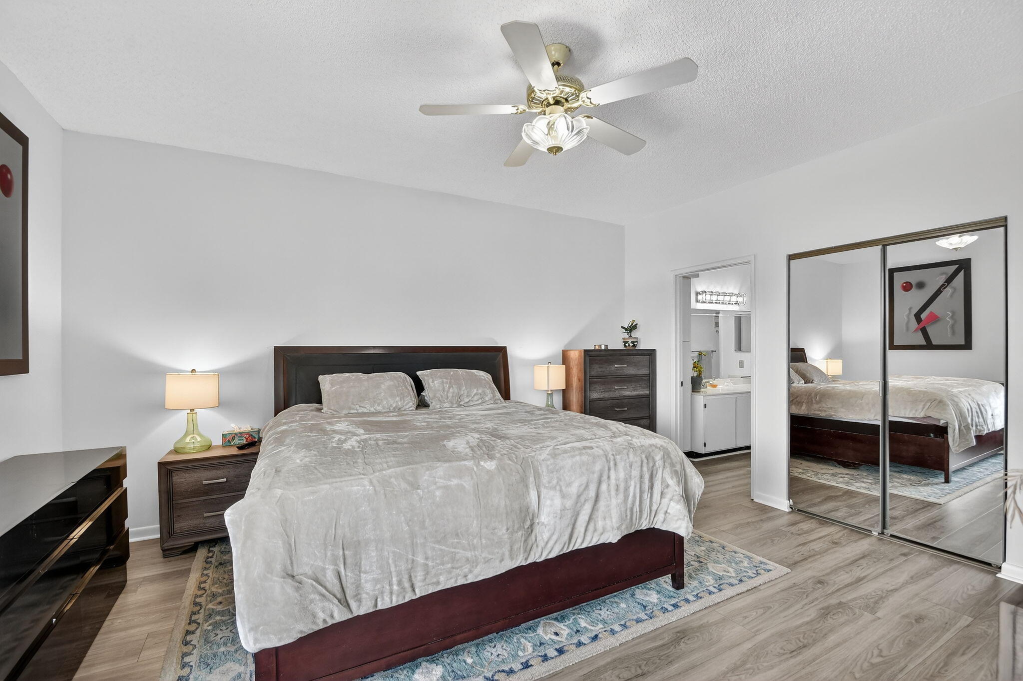 6193 Pointe Regal Circle, Unit 402 Delray Beach, FL 33484 - Photo 22 of 104 a bedroom with a bed and a chandelier