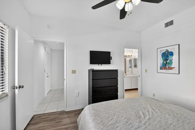 a view of a patio with a table and chairs under an umbrella