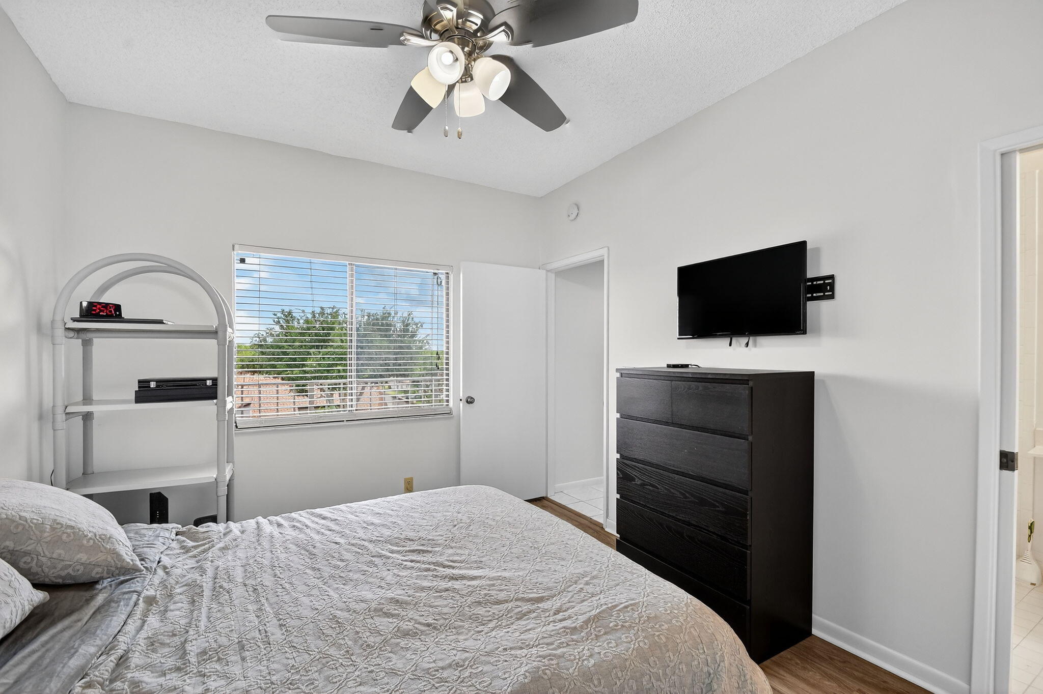 6193 Pointe Regal Circle, Unit 402 Delray Beach, FL 33484 - Photo 30 of 104 a bedroom with a bed and a flat screen tv