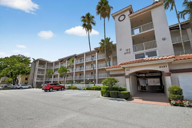 a kitchen with a sink white cabinets and white appliances