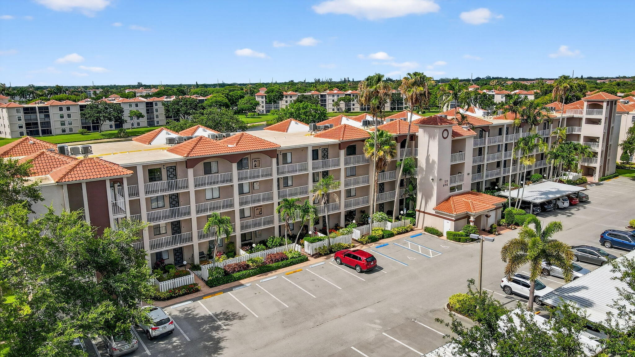 6193 Pointe Regal Circle, Unit 402 Delray Beach, FL 33484 - Photo 34 of 104 a view of a patio with table and chairs and potted plants