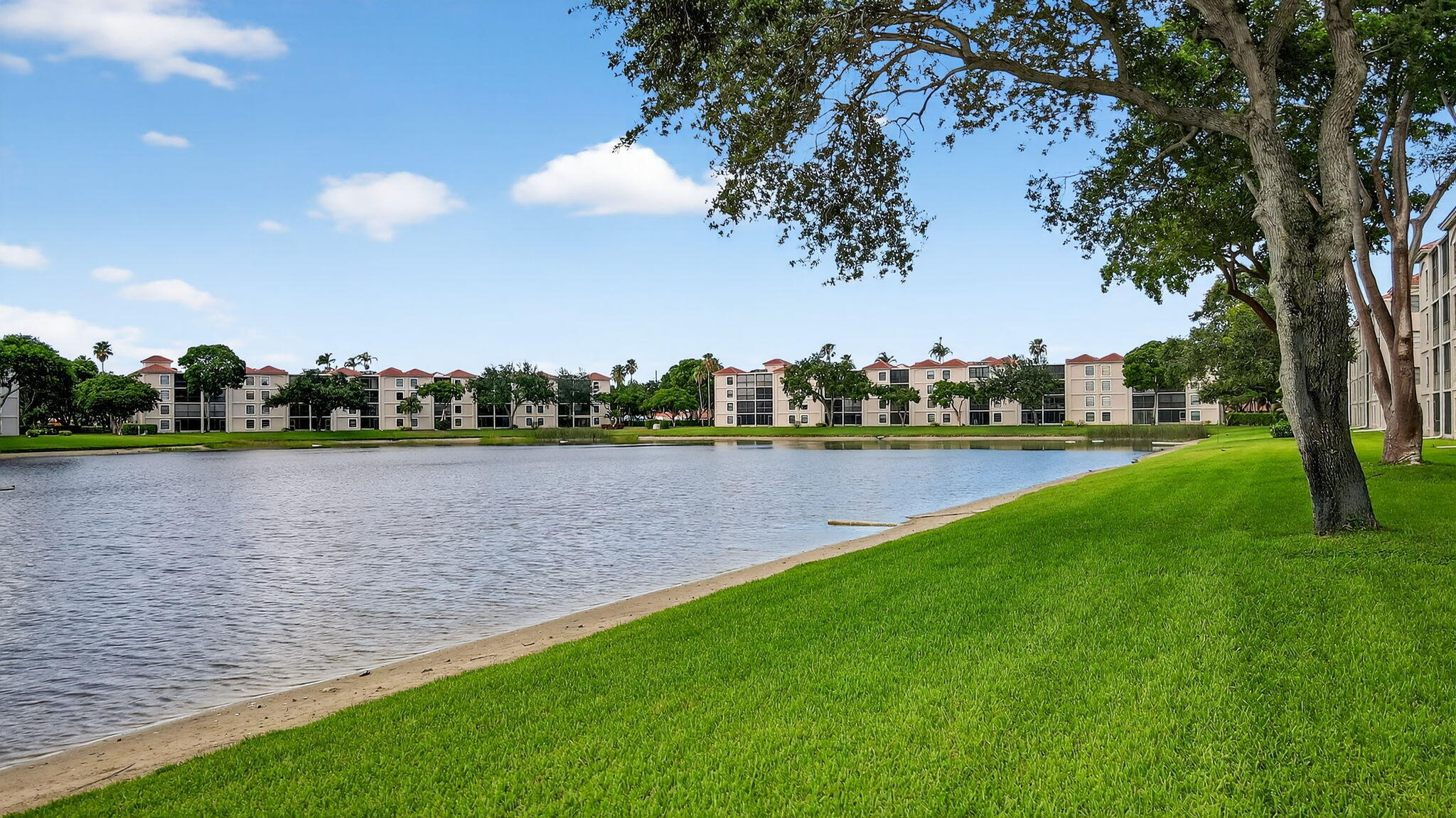 6193 Pointe Regal Circle, Unit 402 Delray Beach, FL 33484 - Photo 41 of 104 a view of a lake with houses in the background