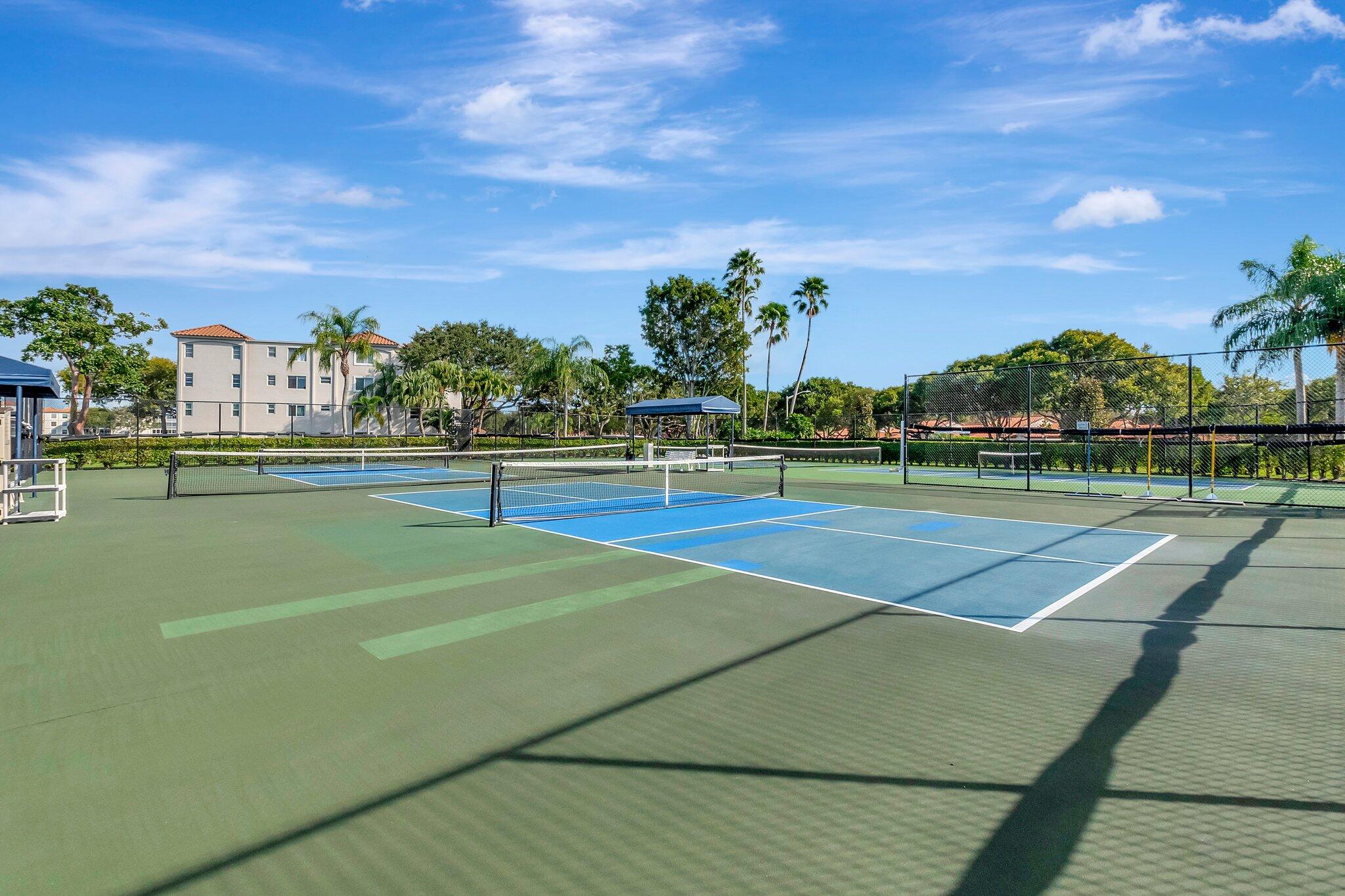 6193 Pointe Regal Circle, Unit 402 Delray Beach, FL 33484 - Photo 99 of 104 a view of an outdoor space and tennis court