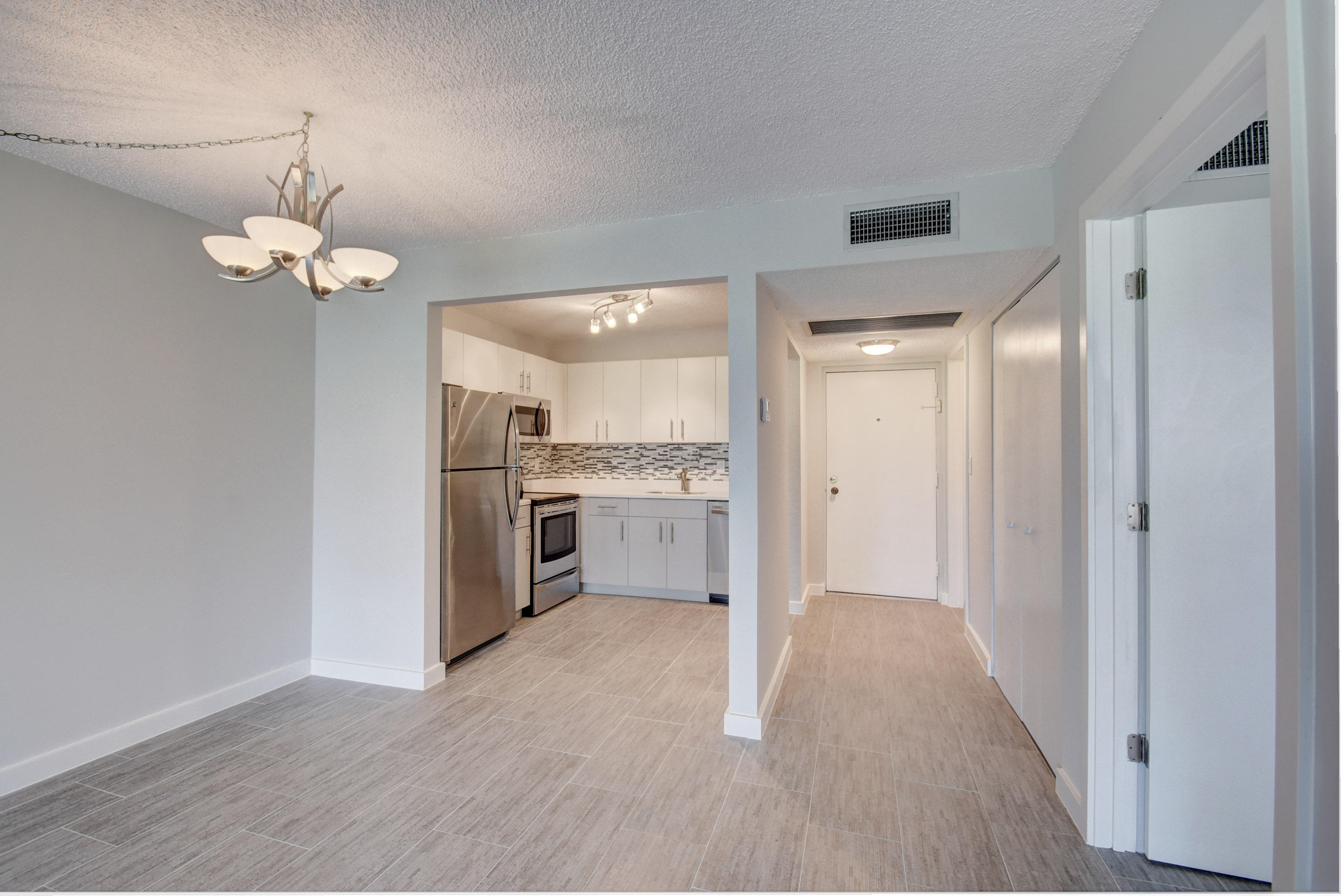 9355 Southwest 8th Street, Unit 120 Boca Raton, FL 33428 - Photo 3 of 21 Living Room/Kitchen/Foyer