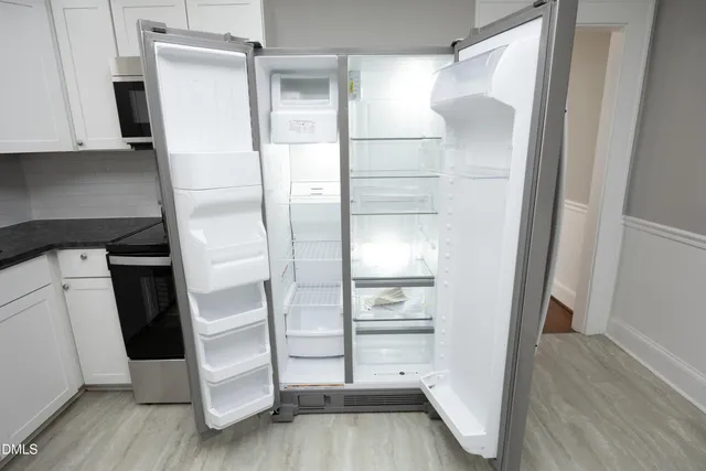 a view of walk in closet with empty racks