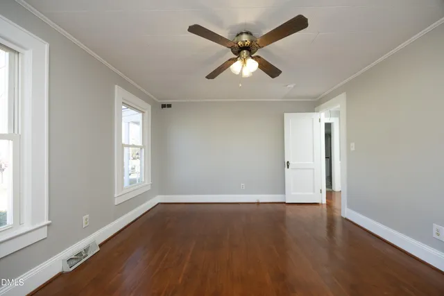 wooden floor in an empty room with a window