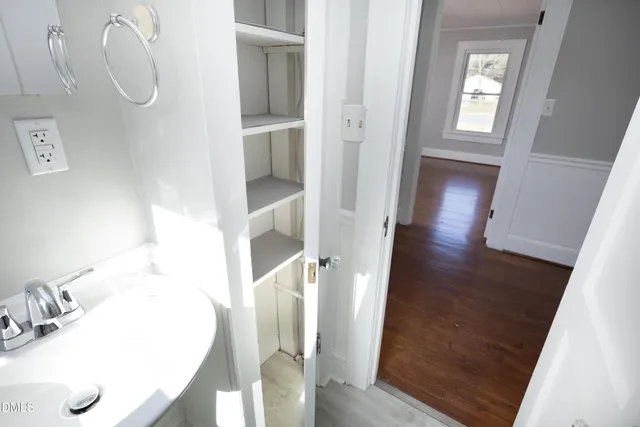 a view of a livingroom with wooden floor and door