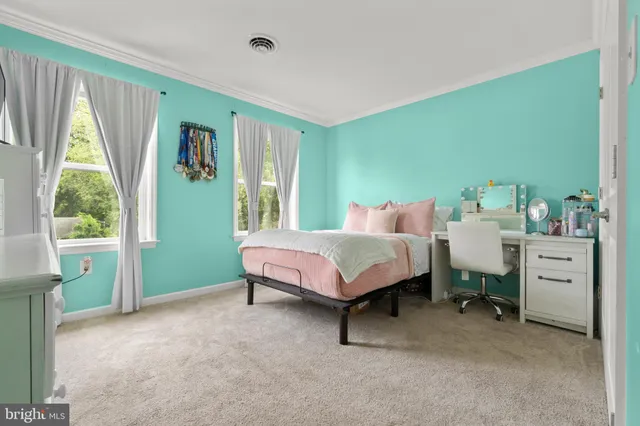 a spacious bedroom with a bed and a table