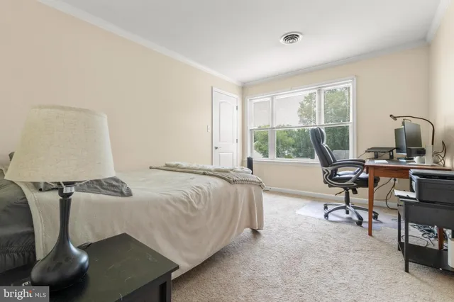 a bedroom with furniture and a window