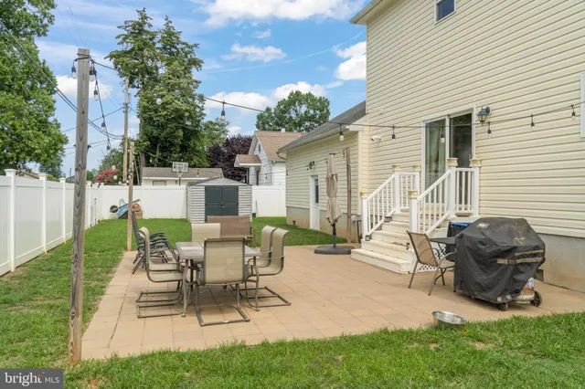 a view of a house with backyard and sitting area