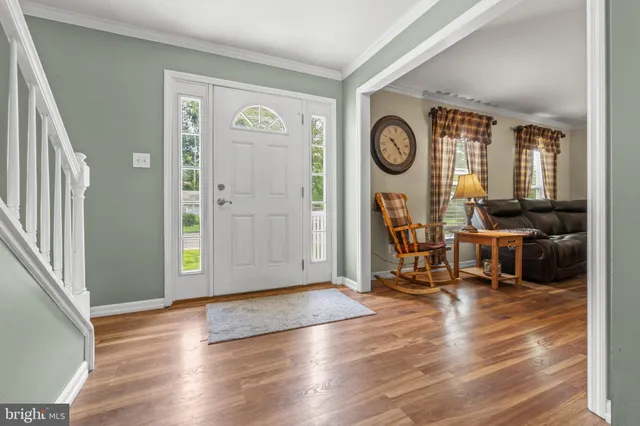 a view of a room with wooden floor and windows