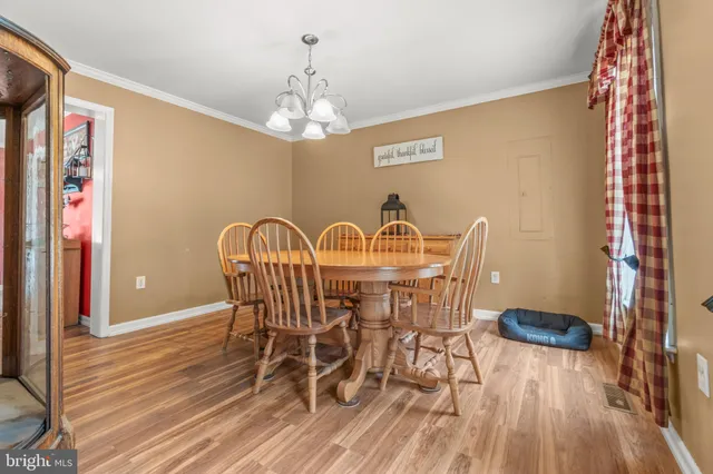 a view of a dining room with furniture and chandelier