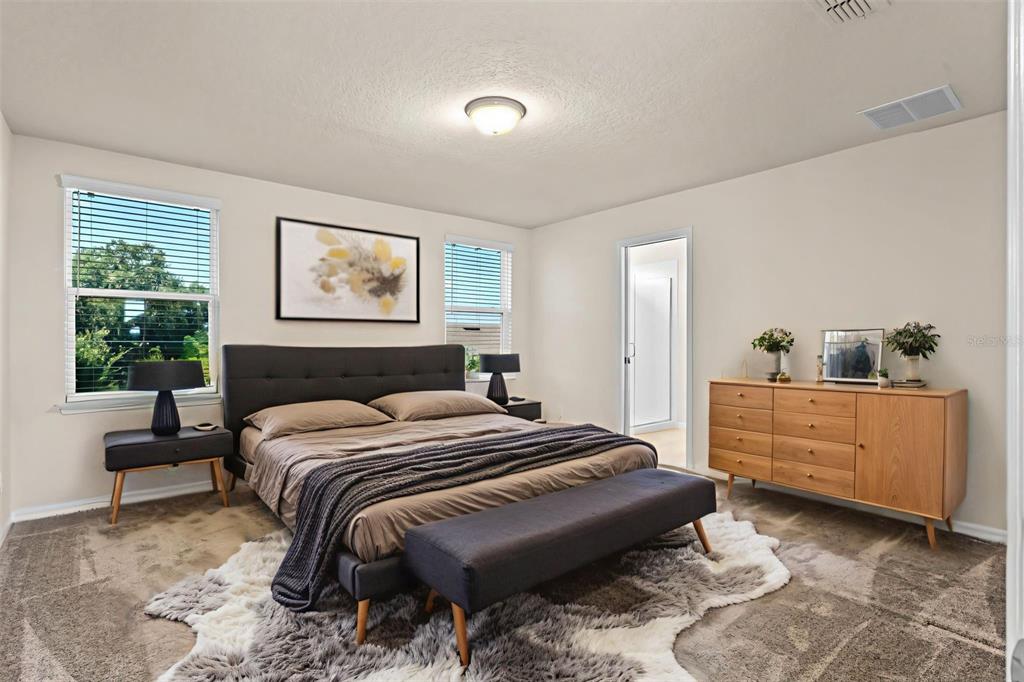 5164 Chickadee Street St. Cloud, FL 34771 - Photo 12 of 35 a bedroom with a bed and a dresser