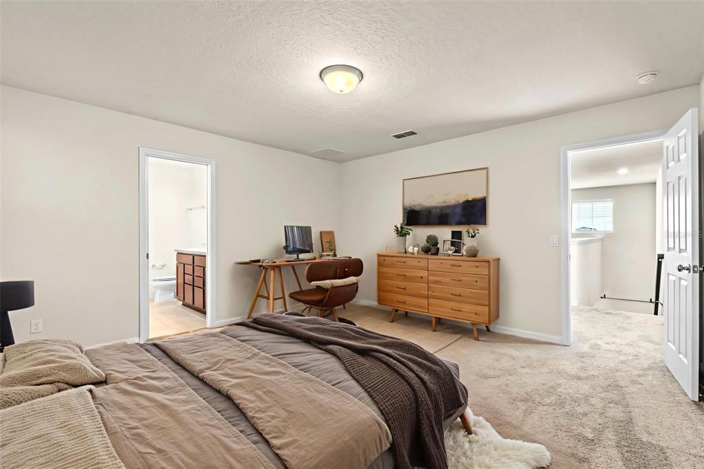 5164 Chickadee Street St. Cloud, FL 34771 - Photo 13 of 35 a bedroom with a bed and wooden floor