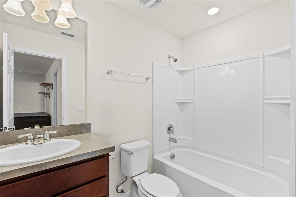 5164 Chickadee Street St. Cloud, FL 34771 - Photo 19 of 35 a bathroom with a sink a toilet and shower