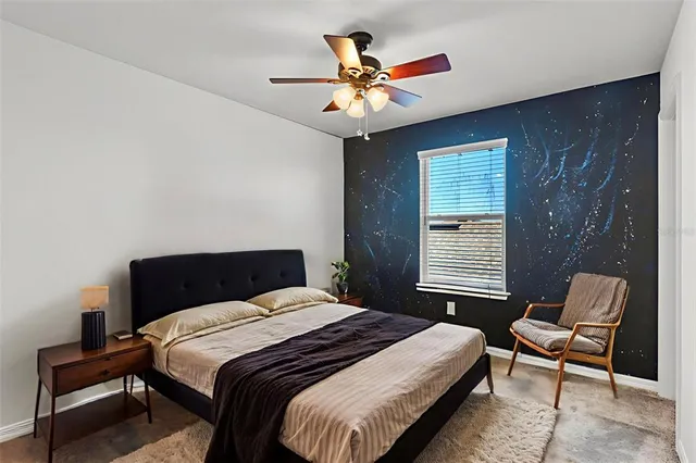 a bedroom with a bed and a window