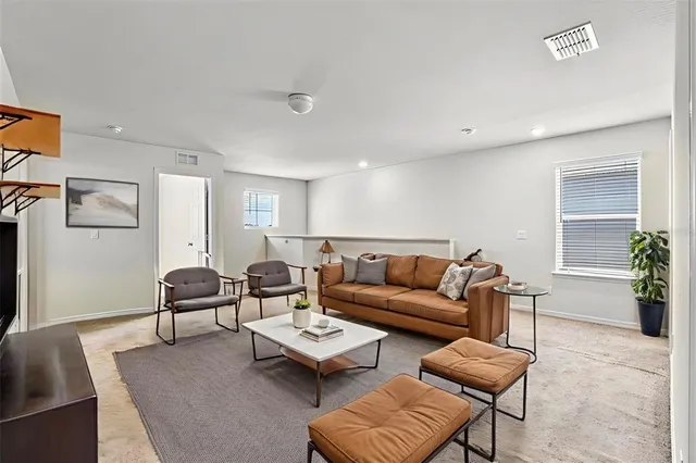a living room with furniture and a potted plant