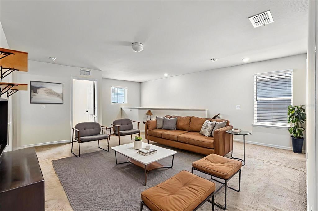 5164 Chickadee Street St. Cloud, FL 34771 - Photo 22 of 35 a living room with furniture and a potted plant