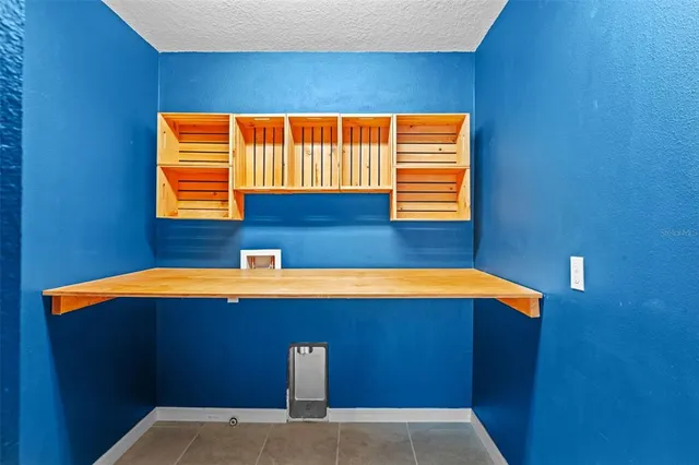 a blue bed sitting in a bathroom next to a blue wall