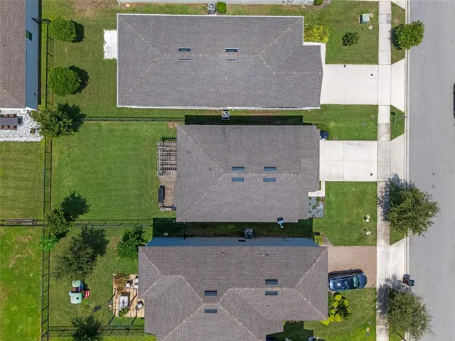 an aerial view of a house with a yard