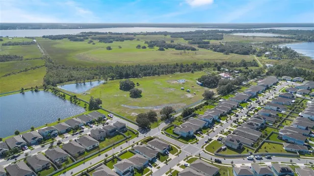 an aerial view of a residential houses with outdoor space