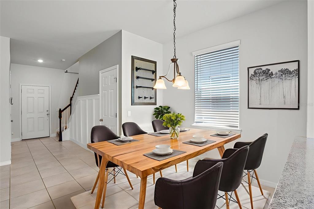 5164 Chickadee Street St. Cloud, FL 34771 - Photo 5 of 35 a view of a dining room with furniture and wooden floor