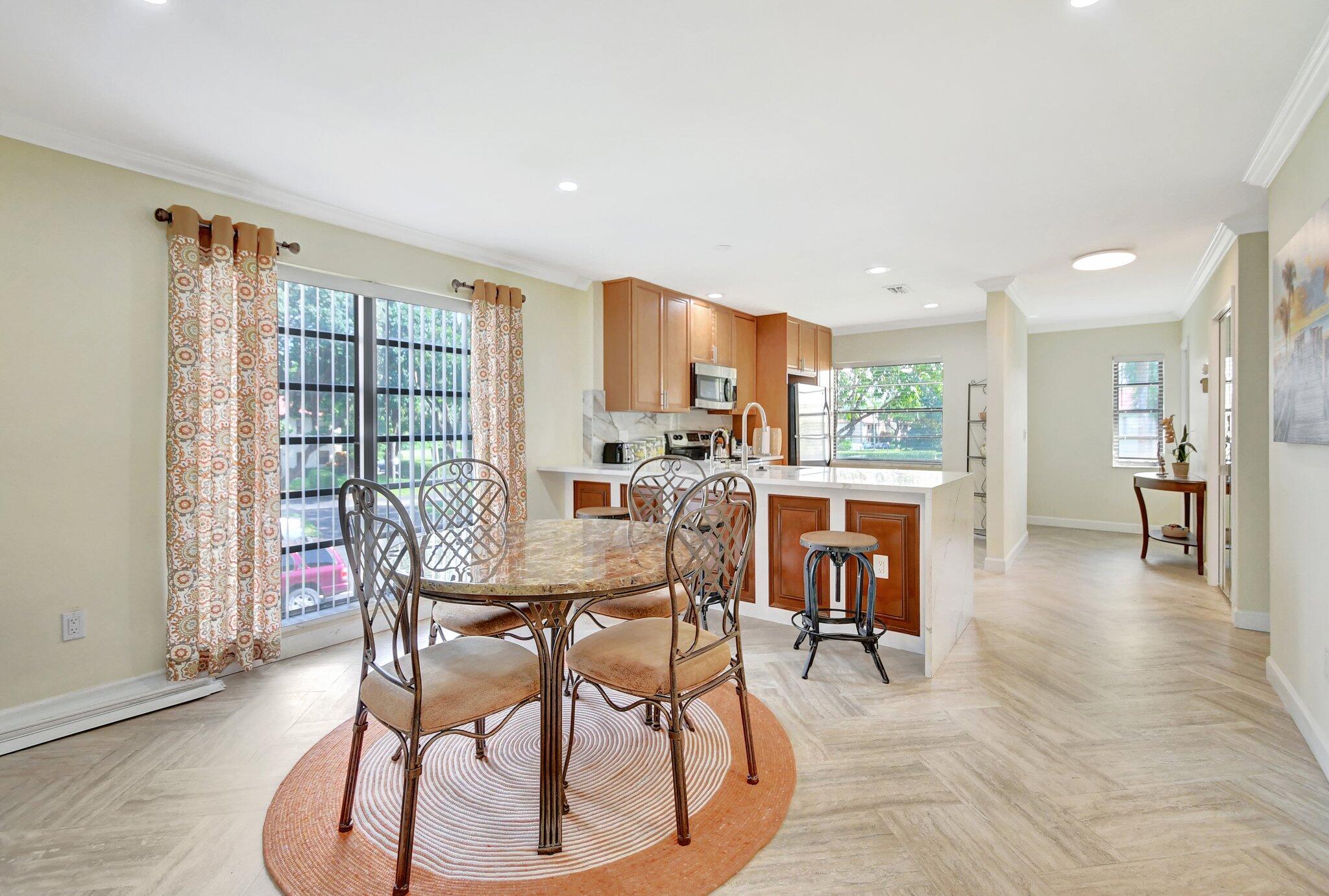 21209 Lago Circle, Unit 12G Boca Raton, FL 33433 - Photo 13 of 39 a view of a dining room with furniture window and outside view