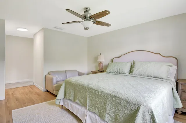 a bedroom with a bed and a ceiling fan