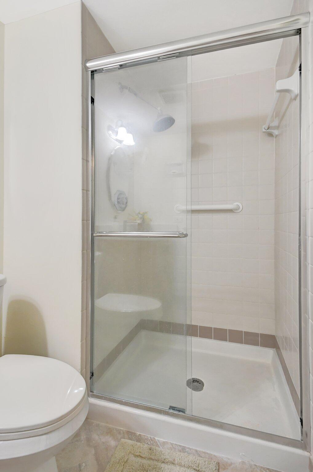 21209 Lago Circle, Unit 12G Boca Raton, FL 33433 - Photo 30 of 39 a bathroom with a shower and a toilet