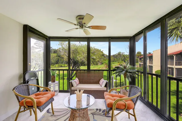 a living room with furniture and a floor to ceiling window