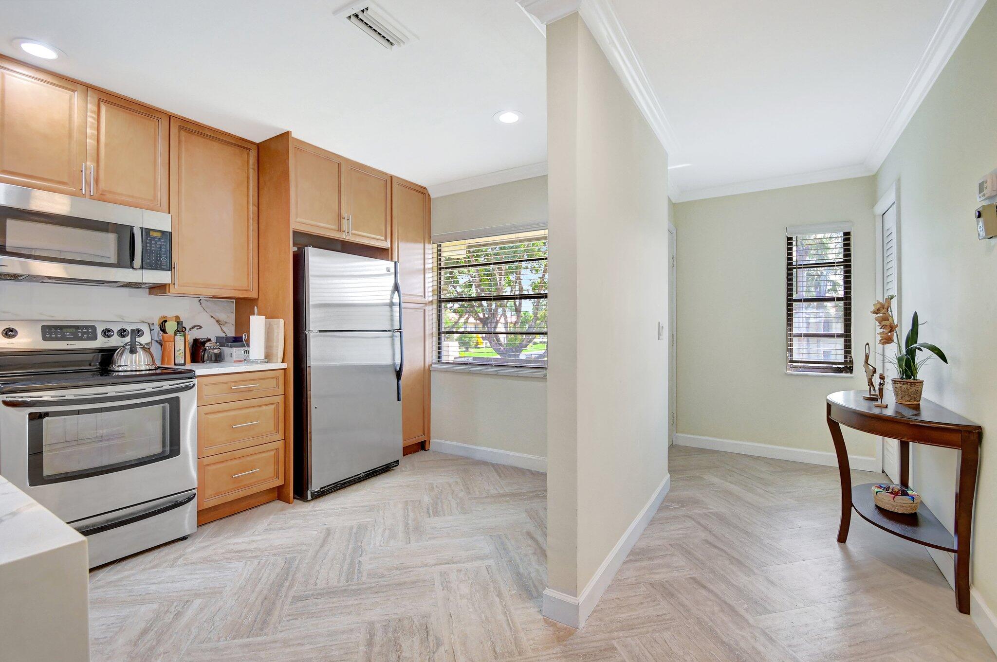 21209 Lago Circle, Unit 12G Boca Raton, FL 33433 - Photo 7 of 39 a kitchen with stainless steel appliances a refrigerator and a stove top oven
