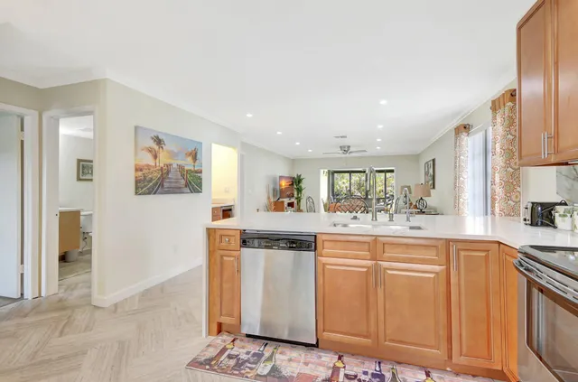 a kitchen with stainless steel appliances granite countertop a refrigerator and a stove top oven