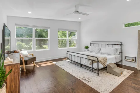 a bedroom with a bed and a large window