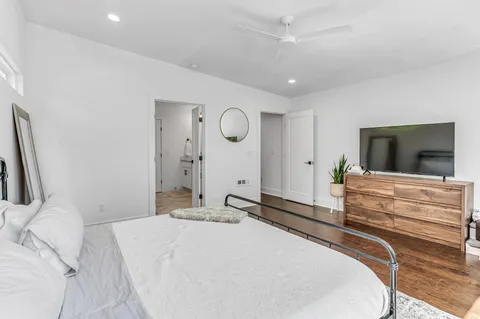 a bedroom with a large bed and a flat screen tv