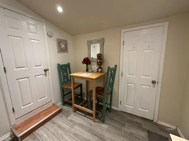 a dining room with furniture and wooden floor