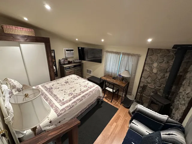 a bed room with furniture and a flat screen tv
