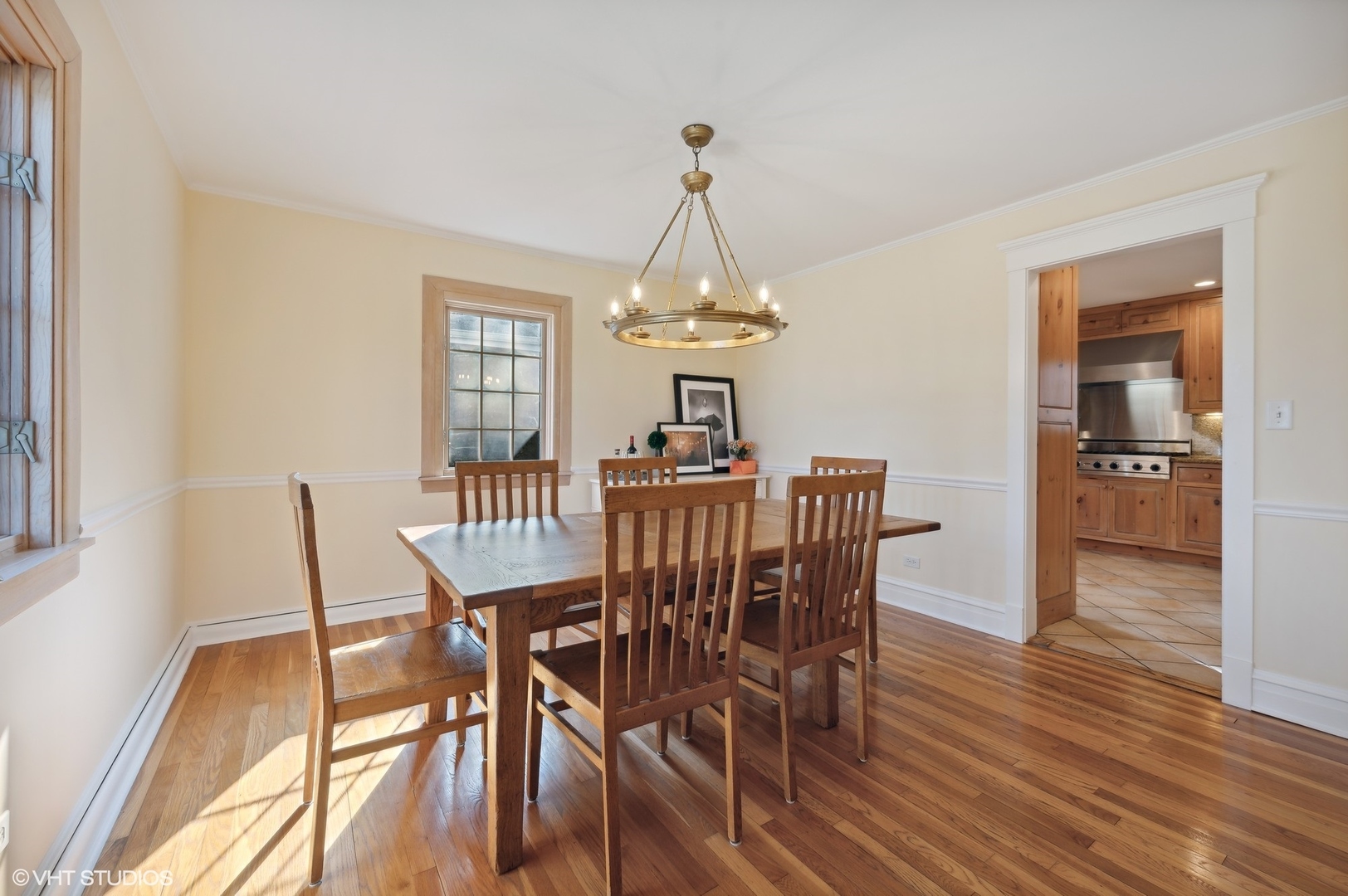 2048 Wagner Road Glenview, IL 60025 - Photo 13 of 37 a dining room with furniture wooden floor a rug and a chandelier