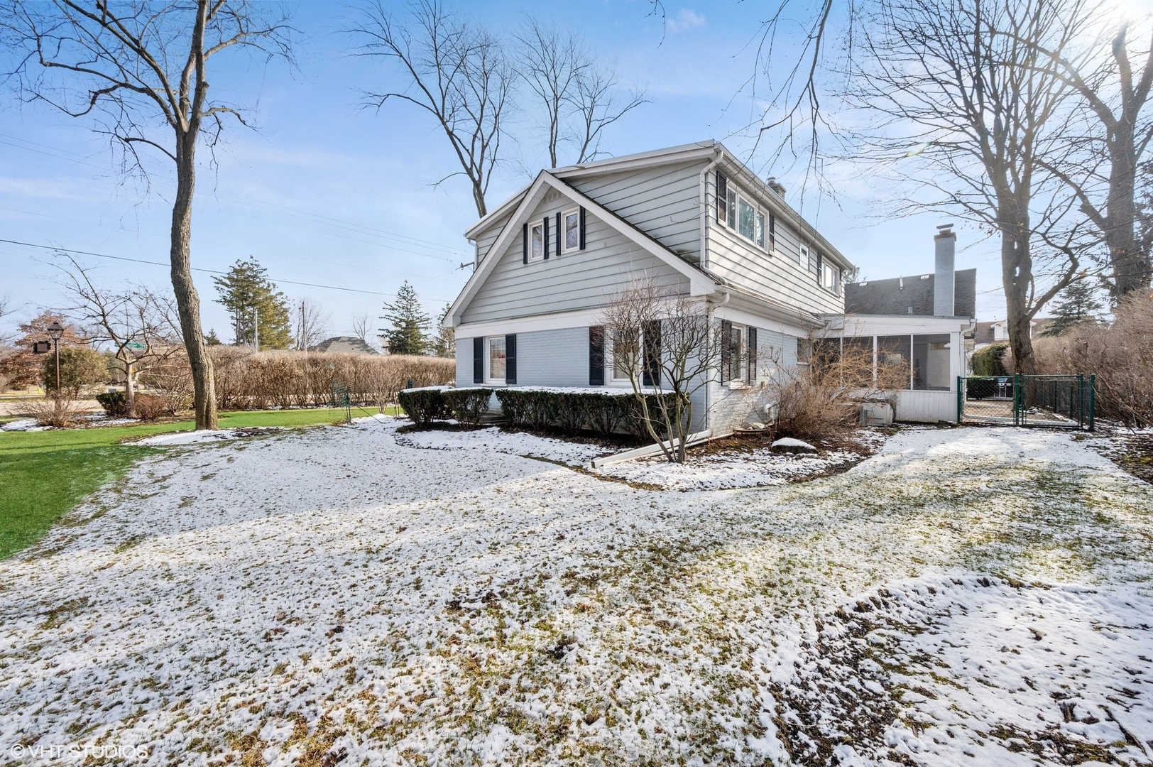 2048 Wagner Road Glenview, IL 60025 - Photo 30 of 37 a front view of a house with a yard covered with snow and trees