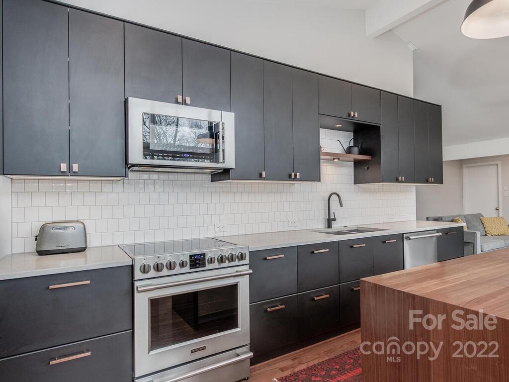 608 Robmont Road Charlotte, NC 28270 - Photo 12 of 25 a kitchen with stainless steel appliances granite countertop a stove a sink and a microwave