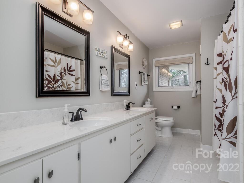 608 Robmont Road Charlotte, NC 28270 - Photo 19 of 25 a spacious bathroom with double vanity a toilet a and a shower