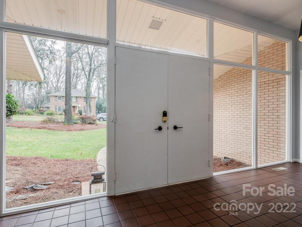608 Robmont Road Charlotte, NC 28270 - Photo 3 of 25 an empty room with wooden floor and windows