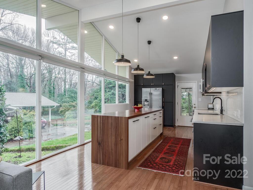 608 Robmont Road Charlotte, NC 28270 - Photo 8 of 25 a kitchen with stainless steel appliances granite countertop a stove and a large window