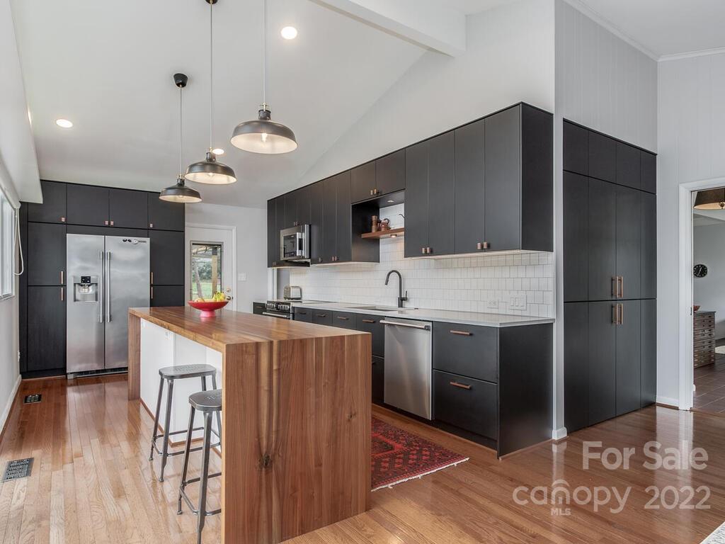 608 Robmont Road Charlotte, NC 28270 - Photo 9 of 25 a kitchen with stainless steel appliances a refrigerator and a stove top oven