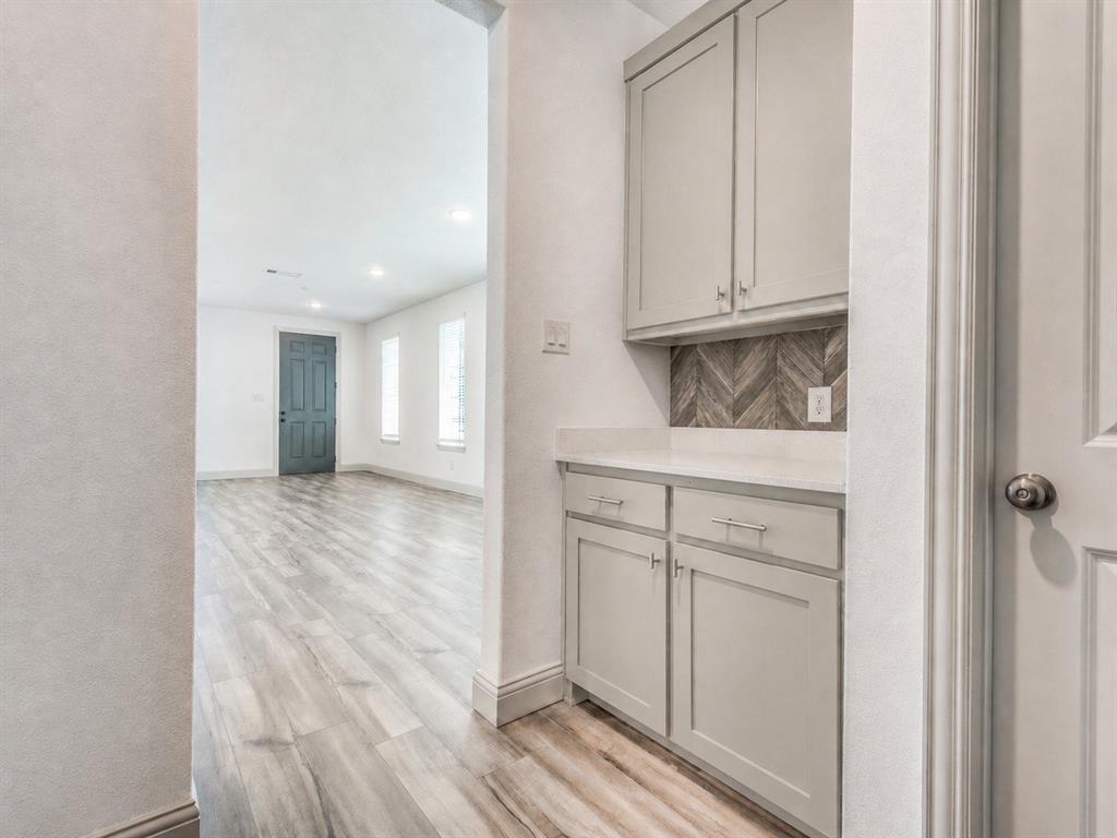 8913 Swallowtail Street Frisco, TX 75035 - Photo 13 of 38 a view of cabinets and wooden floor