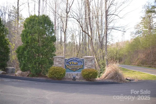 a view of a street sign under a large tree