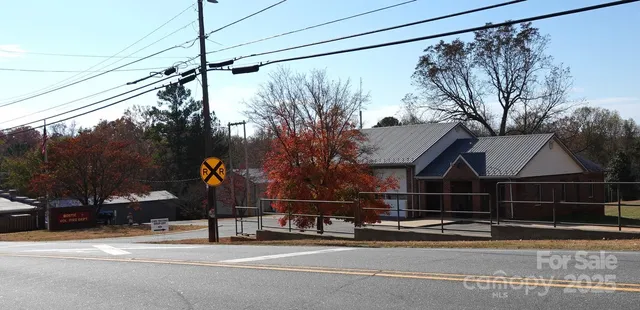 a view of a street with a car parked on the road