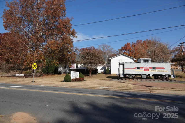 a sign board with buildings in the background