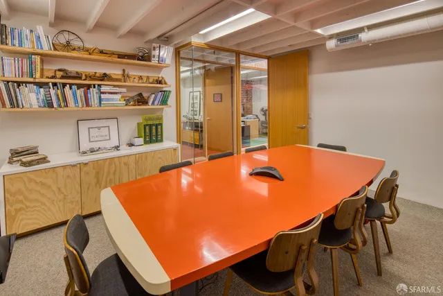 a view of a room with furniture and book shelf